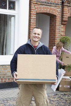 Removal team planning a move in Southall with packed boxes and furniture