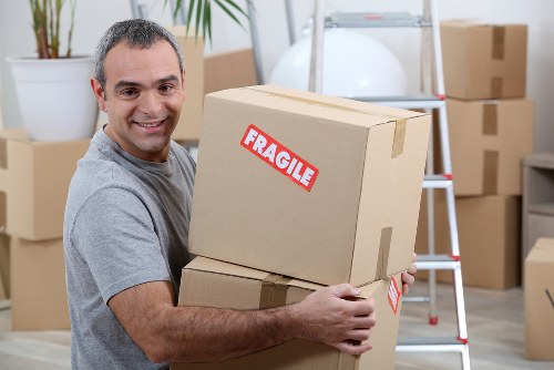 Boxes and furniture being assessed for a transparent Southall storage quote