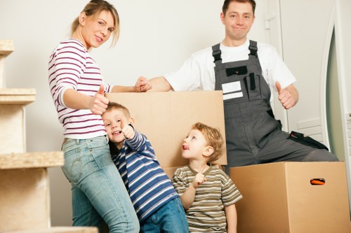Family settling into a new home after house removals in Southall
